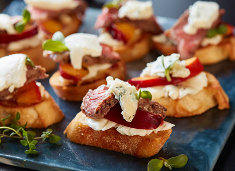 Cheesy Crostini with Peaches & Steak